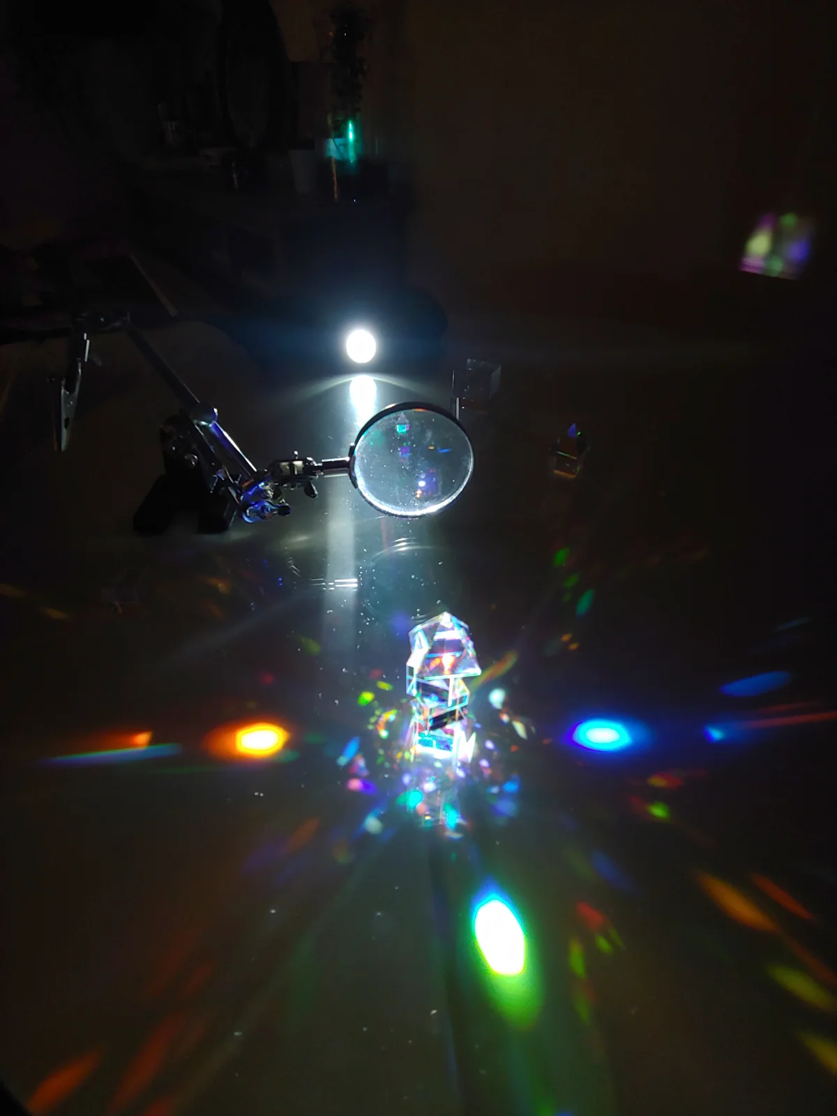 A small bedroom setup with a torch and optical objects.