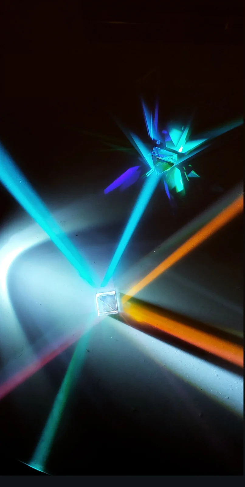 Coloured beams refracted through a small prism setup.