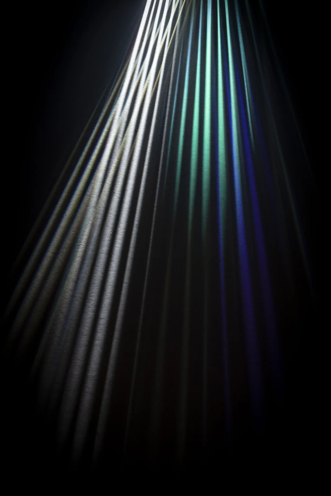 Parallel rays of light spreading from a prism.