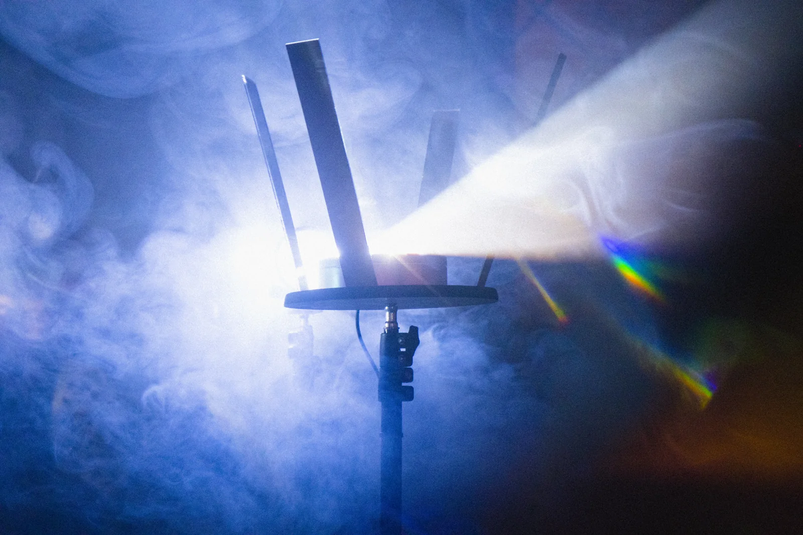 The prism setup surrounded by smoke and white light.