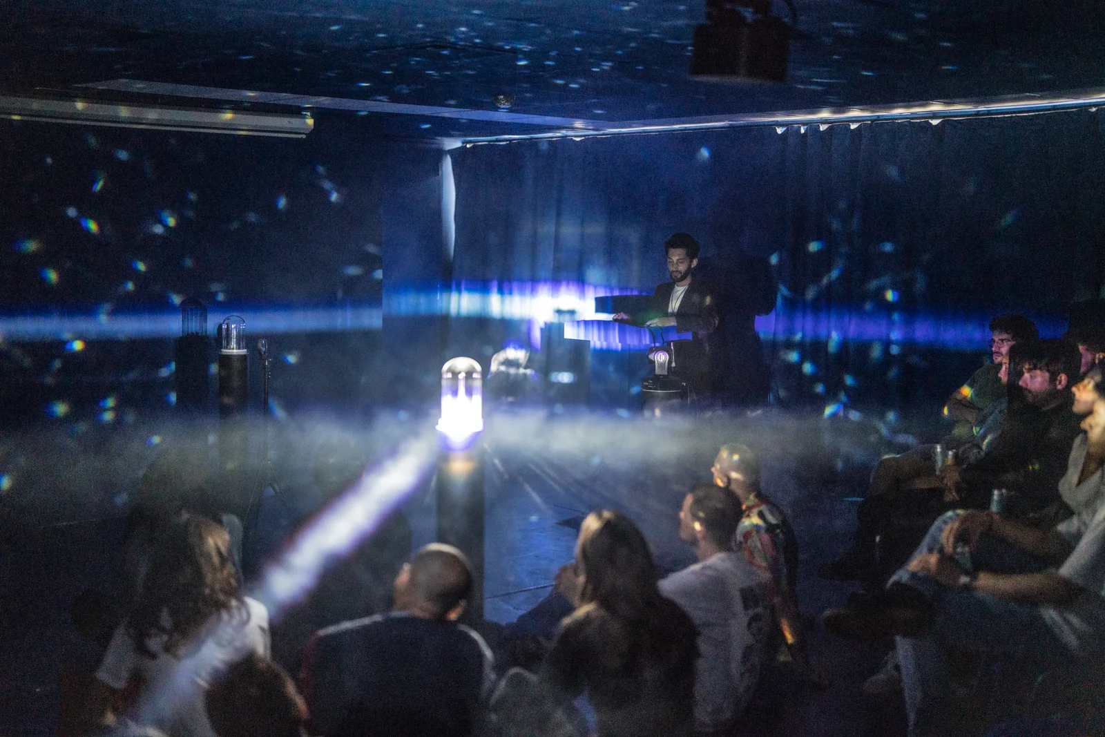Visitors gathered around the new light installation at Open Studios in July 2023.