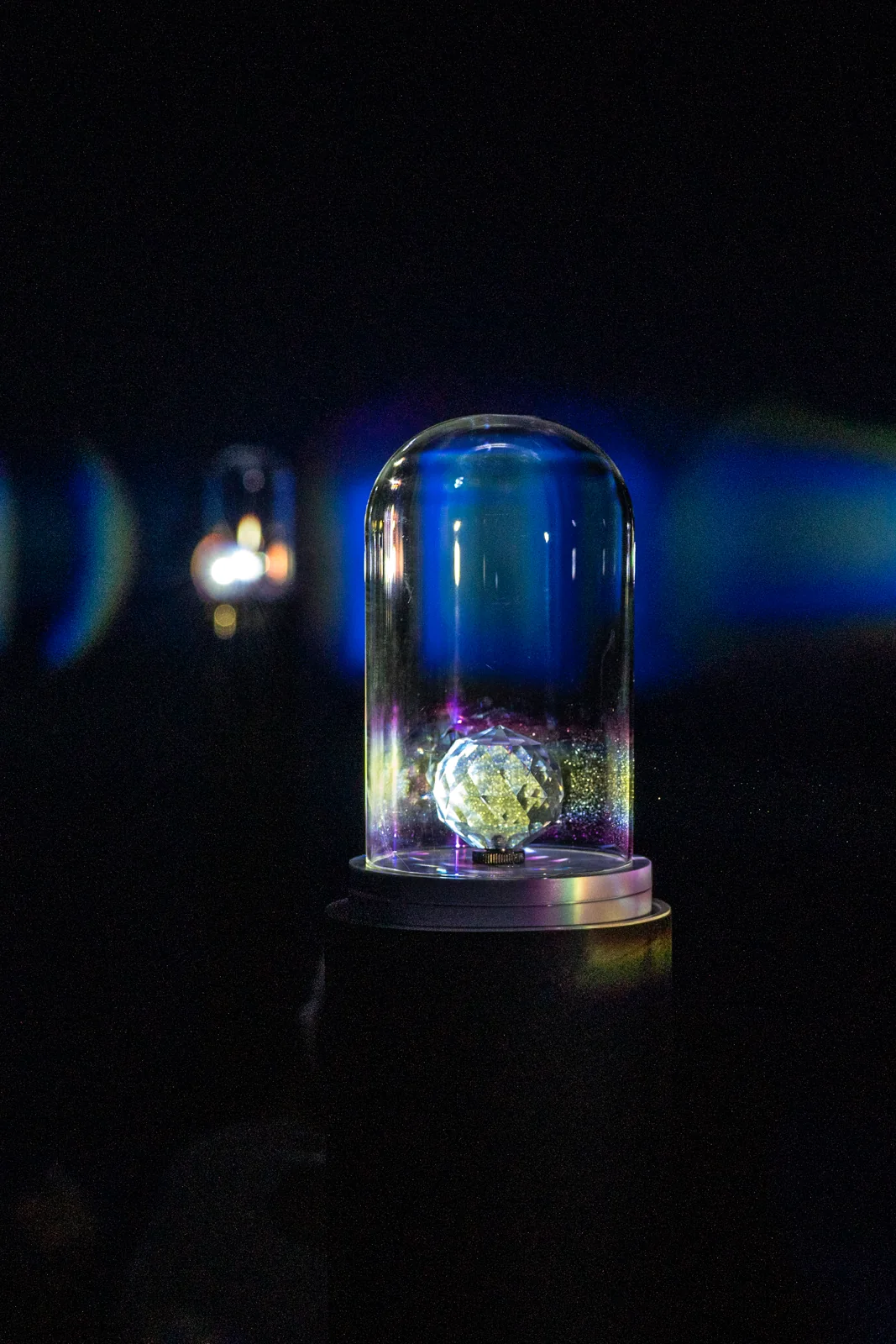 The prism installation beneath its glass dome.