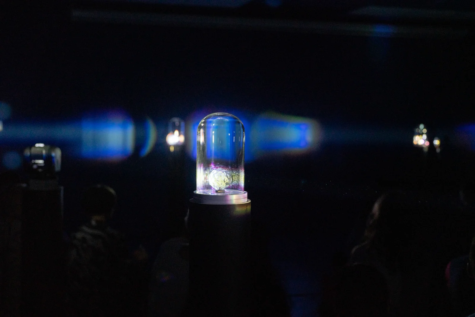 Light radiates from the central installation.
