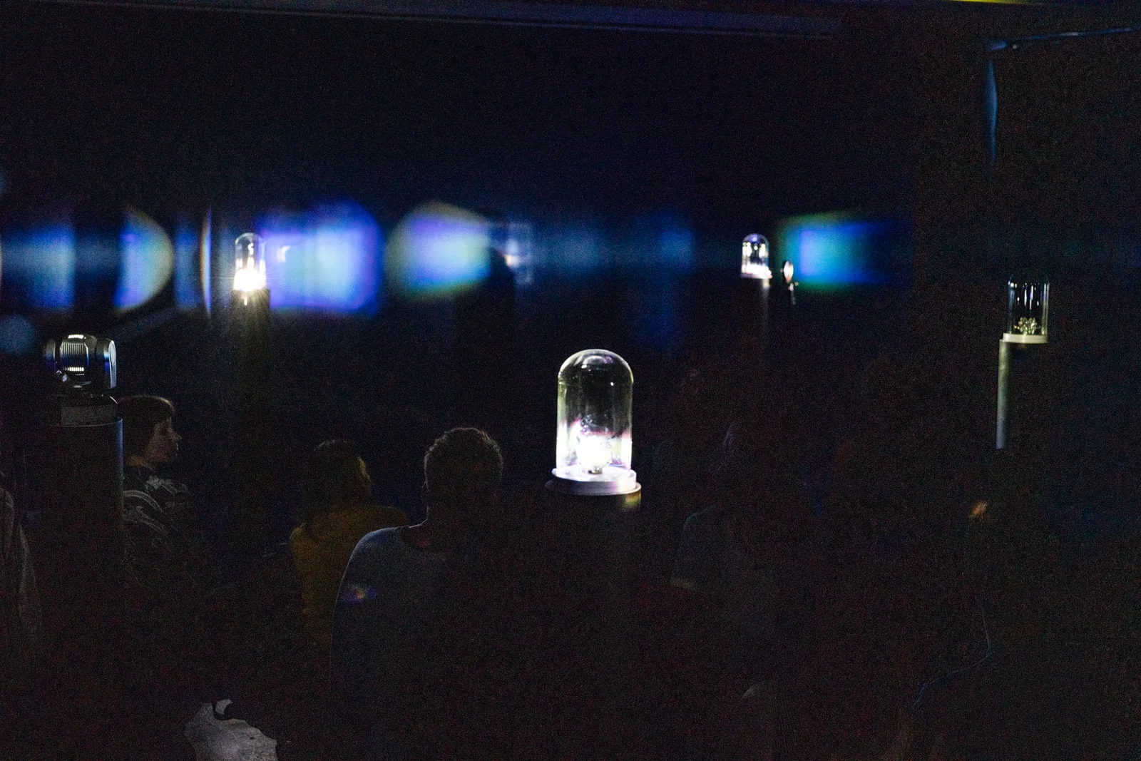 The audience watches the installation in darkness.