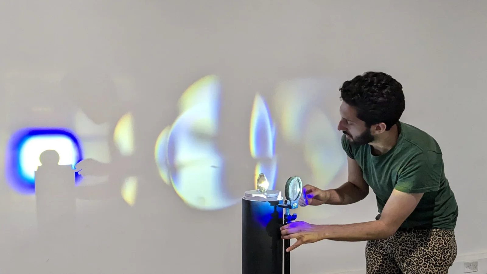 Adjusting prisms and coloured projections before the event.