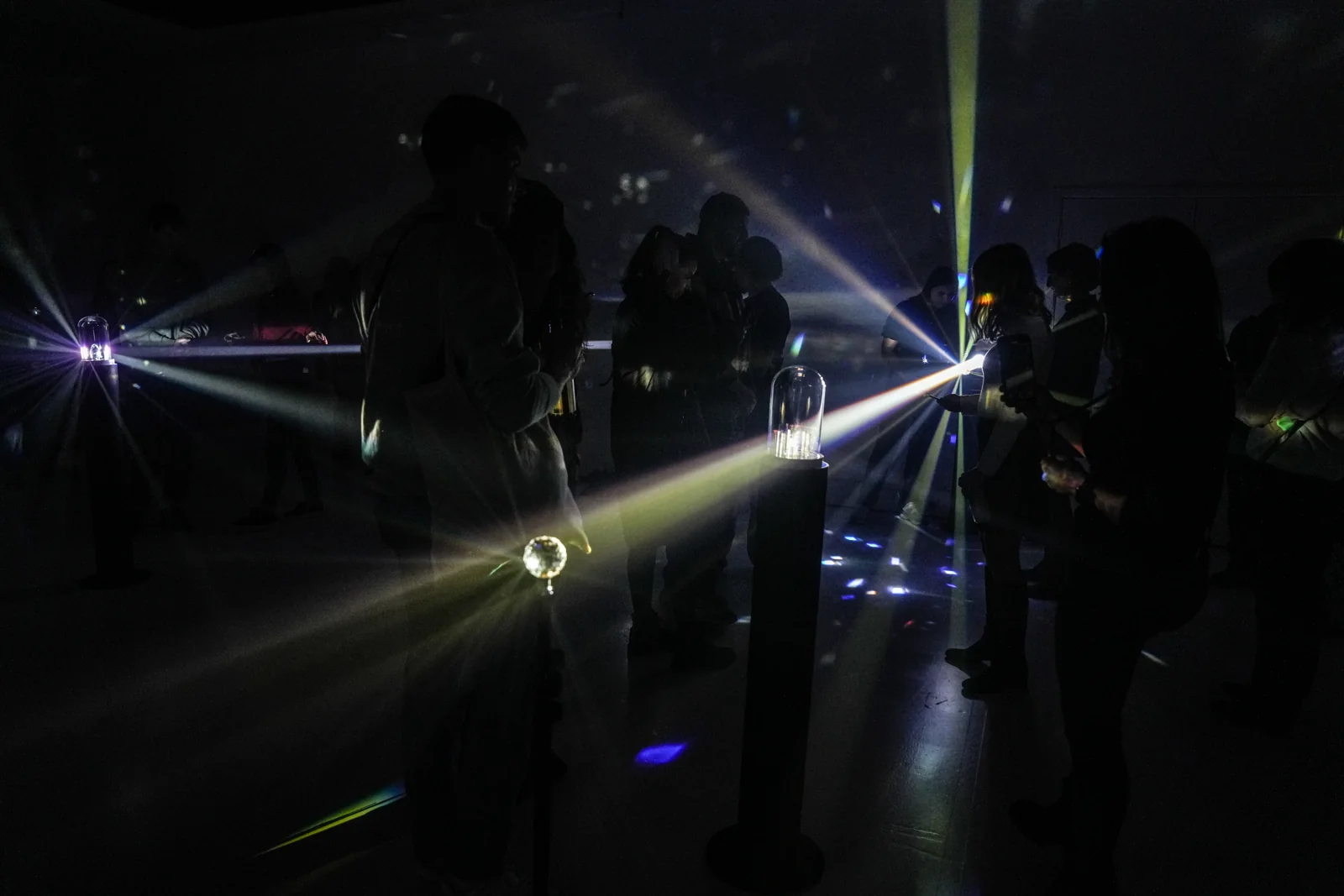 Visitors surrounded by the choreographed beams of light.