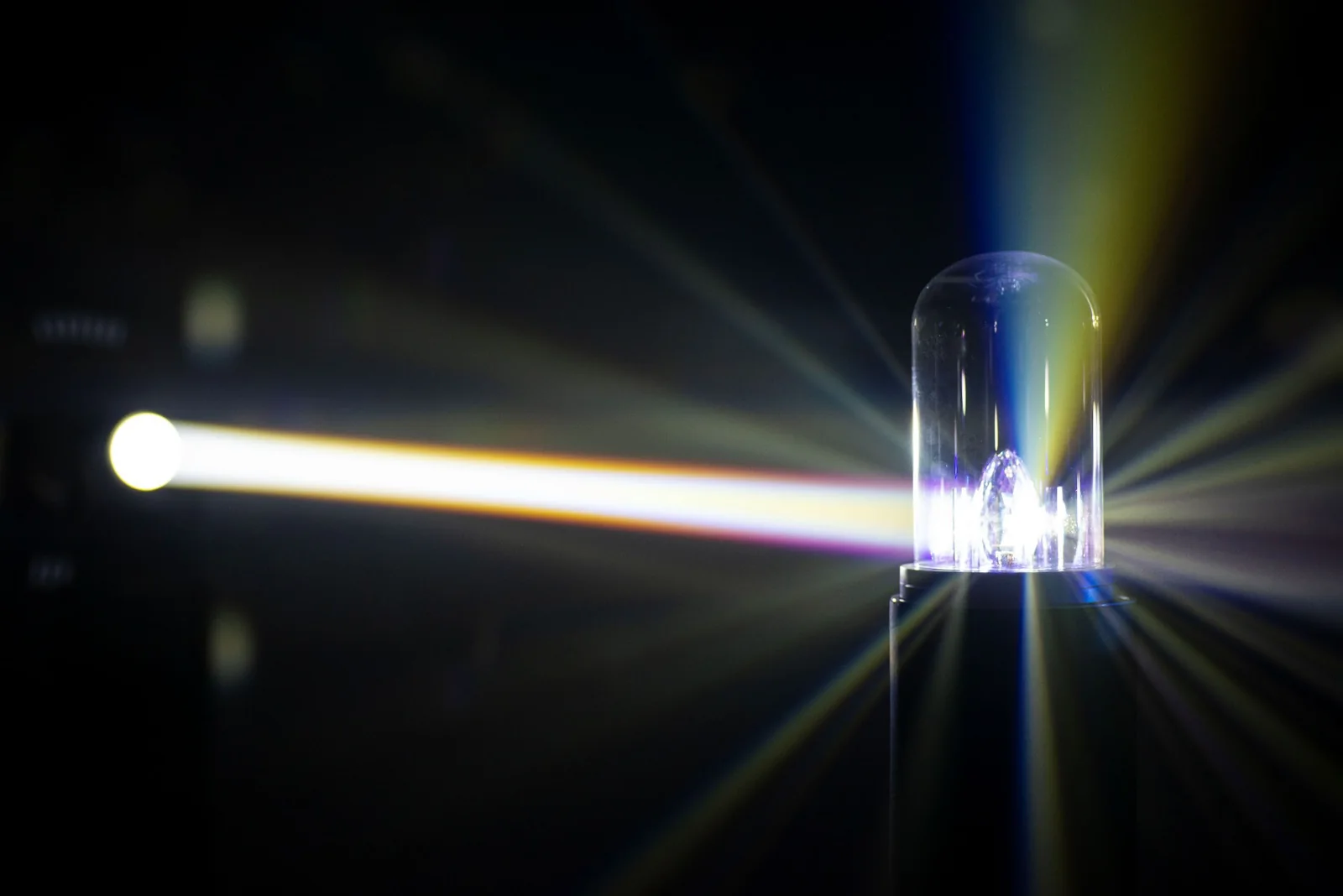 White and coloured beams radiate from the glass-domed installation.