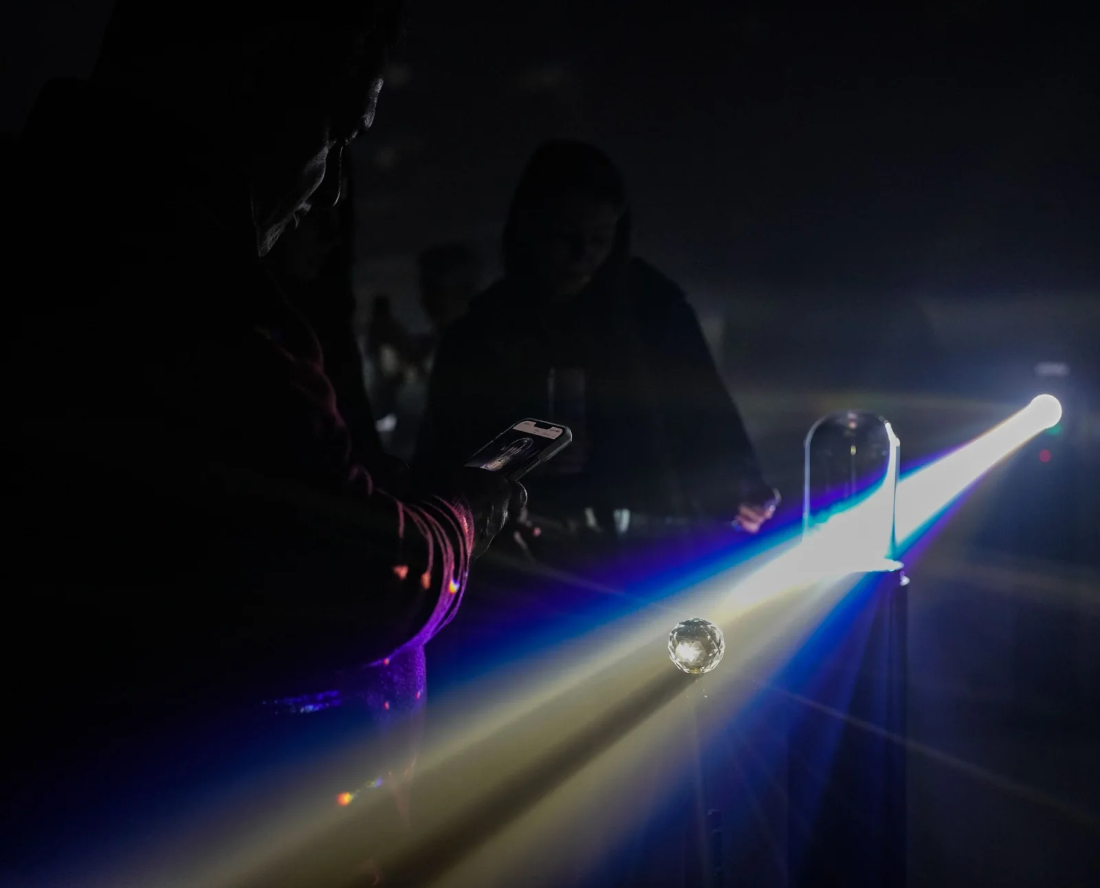 A visitor surrounded by rays of light during the finale.