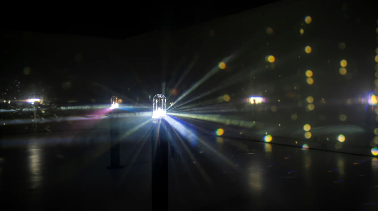 The final installation scatters light across the gallery.