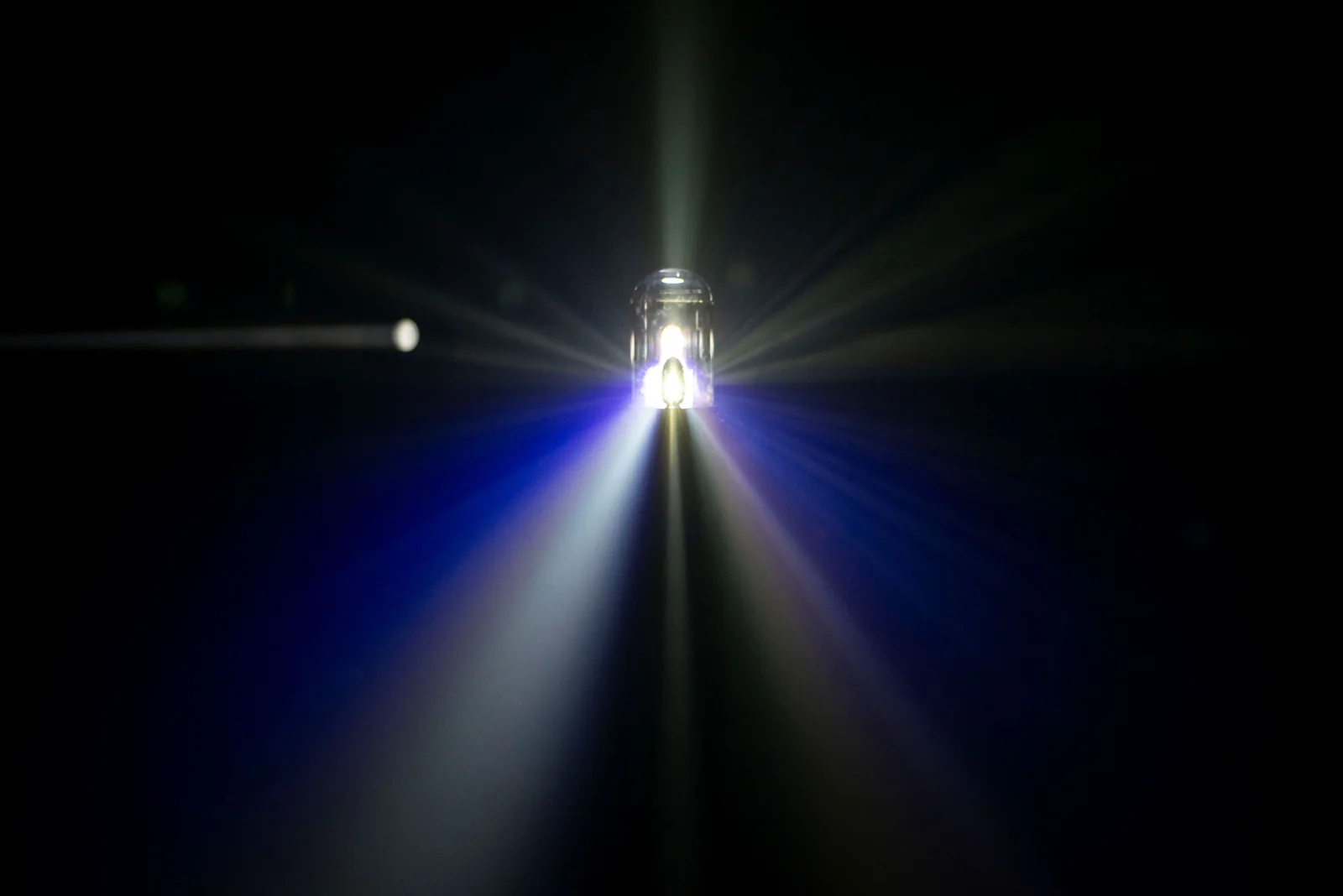 A spectrum of light fans out from the glass-domed prism setup.