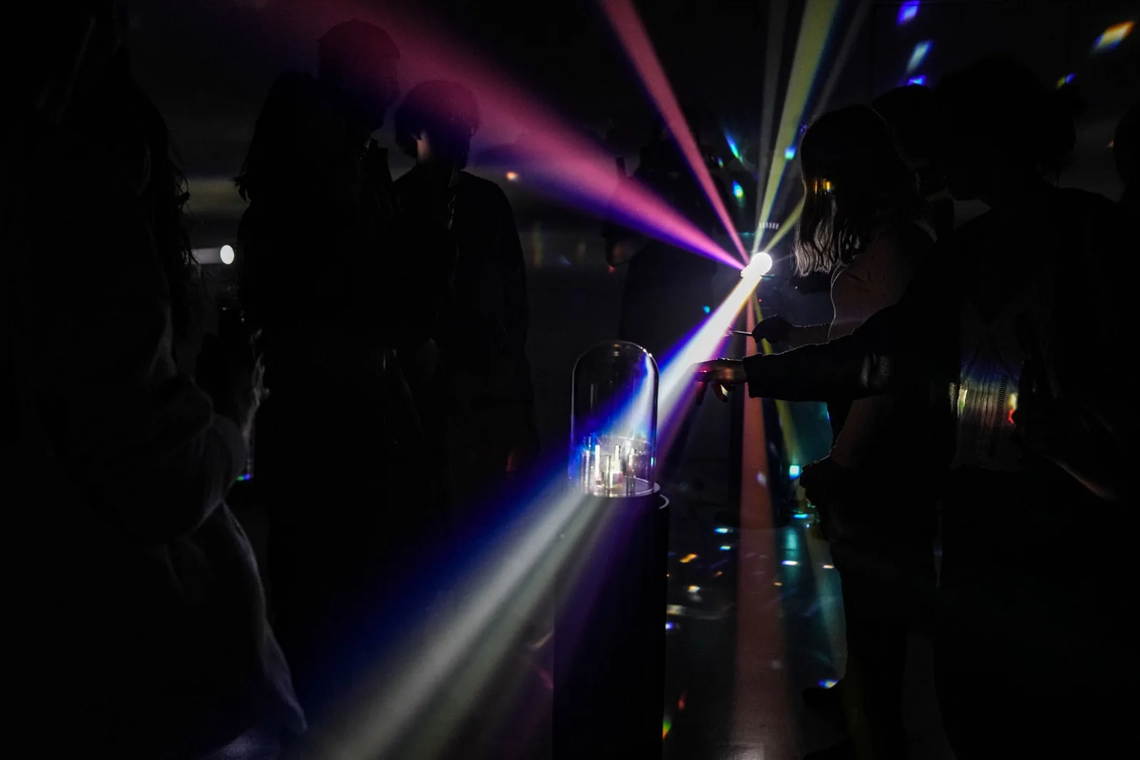 Visitors explore coloured beams together at the finale.