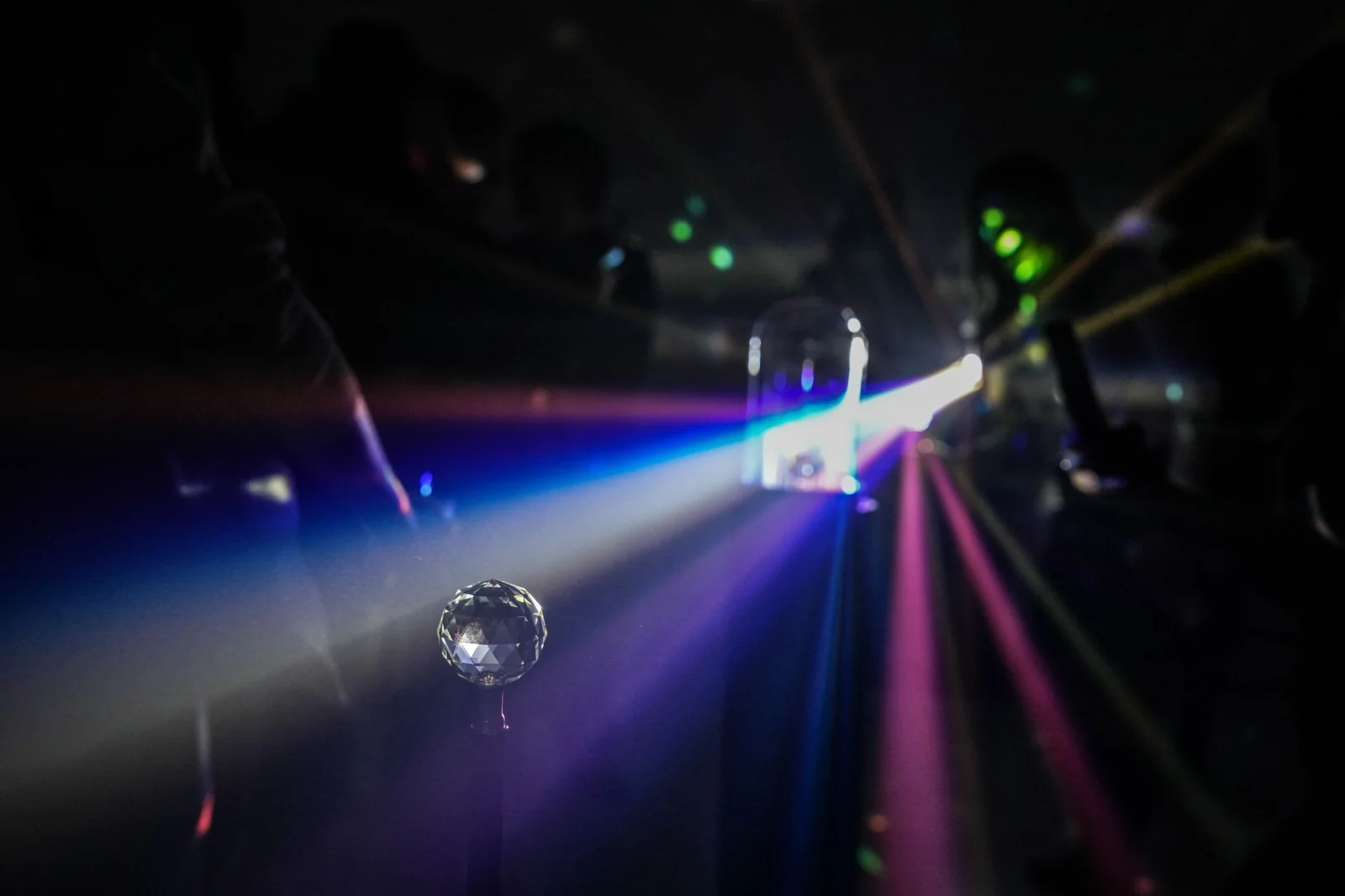 A visitor bends light through a prism in the final installation.